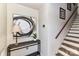 Inviting foyer with staircase, modern artwork, and stylish console table at 7804 Renaissance Ct # A, Charlotte, NC 28226