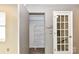 A hallway with a closet and door, featuring hardwood style flooring and neutral-colored walls at 7804 Renaissance Ct # A, Charlotte, NC 28226