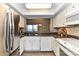 Functional kitchen with white cabinets, stainless steel refrigerator, and open view to the dining area at 7804 Renaissance Ct # A, Charlotte, NC 28226
