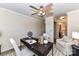 Cozy office space featuring a modern ceiling fan, desk, chair, and bright natural light at 7804 Renaissance Ct # A, Charlotte, NC 28226
