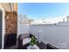 Private patio area with white fence, stylish outdoor furniture, and a view of the open sky at 7804 Renaissance Ct # A, Charlotte, NC 28226