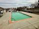 Community pool with brick trim and well-maintained concrete patio area at 7804 Renaissance Ct # A, Charlotte, NC 28226