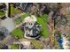 Aerial view of the property showcasing the home's layout, landscaping, driveway, and an outdoor entertaining area at 888 Craigmont Nw Ln, Concord, NC 28027