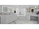 Luxurious bathroom with a freestanding tub, dual vanities, and marble countertops and flooring at 888 Craigmont Nw Ln, Concord, NC 28027