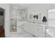 Modern bathroom with a glass-enclosed shower, dual sinks, and marble accents at 888 Craigmont Nw Ln, Concord, NC 28027
