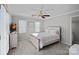 A cozy bedroom with a ceiling fan, dresser, plush bedding, and natural light coming through window blinds at 888 Craigmont Nw Ln, Concord, NC 28027