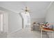 A spacious bedroom with a ceiling fan, carpeted floor, and a sewing machine on a table at 888 Craigmont Nw Ln, Concord, NC 28027