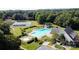 A lovely community pool area with well maintained landscaping and a tennis court visible behind the pool at 888 Craigmont Nw Ln, Concord, NC 28027
