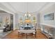 Formal dining area with a glass table, upholstered seating, and large windows at 888 Craigmont Nw Ln, Concord, NC 28027