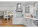 Bright kitchen features white cabinetry, stainless steel appliances, and a mosaic tile backsplash at 888 Craigmont Nw Ln, Concord, NC 28027