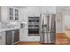 Modern kitchen with stainless steel appliances, white cabinetry, and hardwood floors at 888 Craigmont Nw Ln, Concord, NC 28027