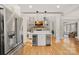 Open-concept living space with a fireplace, built-in shelving, and wood floors, adjacent to the kitchen at 888 Craigmont Nw Ln, Concord, NC 28027