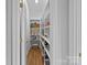 Walk-in pantry with ample shelving space for storage at 888 Craigmont Nw Ln, Concord, NC 28027