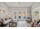 Relaxing sunroom features a seating area, ceiling fan, and French doors leading to the backyard at 888 Craigmont Nw Ln, Concord, NC 28027