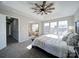 Bright main bedroom features a trey ceiling with modern ceiling fan, large windows, and neutral decor at 9726 Ashburton Dr, Charlotte, NC 28216