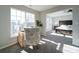 Sitting room shows a light-filled space with a modern desk and chair, neutral walls, and carpeted floors at 9726 Ashburton Dr, Charlotte, NC 28216