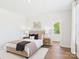 Bright bedroom features a cushioned bed frame, hardwood floors and view to the exterior at 1010 Rolling Meadows Dr # Rm14, Mooresville, NC 28115