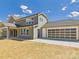 Back exterior view showcasing covered patio, grassy yard and attached garage at 1010 Rolling Meadows Dr # Rm14, Mooresville, NC 28115