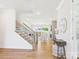 Bright foyer with wood floors, staircase, and elegant decor leads into an open living space with a stone fireplace at 1010 Rolling Meadows Dr # Rm14, Mooresville, NC 28115