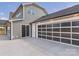 Attached two-car garage with a modern frosted-glass door and exterior lighting, with driveway and siding at 1010 Rolling Meadows Dr # Rm14, Mooresville, NC 28115