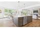 Modern kitchen with stainless steel appliances, island, and adjacent dining area at 1010 Rolling Meadows Dr # Rm14, Mooresville, NC 28115