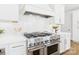 Close-up of a modern kitchen with stainless steel oven, range, and white cabinets at 1010 Rolling Meadows Dr # Rm14, Mooresville, NC 28115
