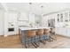 Gourmet kitchen featuring a large island with seating, white cabinets, and pendant lighting at 1010 Rolling Meadows Dr # Rm14, Mooresville, NC 28115