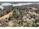 Scenic aerial view of a lakeside community with lush trees, golf course, and beautiful homes at 1205 Molokai Dr, Tega Cay, SC 29708
