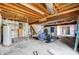 Unfinished basement with exposed beams, stairs, gym equipment, and potential for customization at 1205 Molokai Dr, Tega Cay, SC 29708