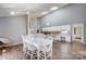 Open-concept dining area with high ceilings and wood floors at 1205 Molokai Dr, Tega Cay, SC 29708