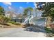 Charming single-Gathering home featuring light blue siding, stone accents, and an attached two-car garage at 1205 Molokai Dr, Tega Cay, SC 29708