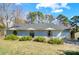 Single-story home with light blue siding, arched windows, well-maintained landscaping, and an attached garage at 1205 Molokai Dr, Tega Cay, SC 29708