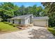 Charming single-story home with a two-car garage, stone accents, arched windows and a well-maintained lawn at 1205 Molokai Dr, Tega Cay, SC 29708