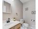 Simple half-bathroom featuring a vanity with sink, toilet, and decorative wall art at 1205 Molokai Dr, Tega Cay, SC 29708
