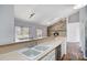 Spacious kitchen featuring stainless steel dishwasher, sink and a stone fireplace at 1205 Molokai Dr, Tega Cay, SC 29708