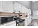 Well-equipped kitchen with stainless steel appliances and sleek white cabinetry at 1205 Molokai Dr, Tega Cay, SC 29708