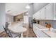 Open kitchen featuring white cabinets, stainless steel appliances, and a unique stone fireplace at 1205 Molokai Dr, Tega Cay, SC 29708