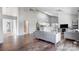 Open-concept living room featuring hardwood floors, vaulted ceiling, and neutral-toned furniture at 1205 Molokai Dr, Tega Cay, SC 29708