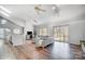 Bright, open living room featuring hardwood floors, vaulted ceiling, and sliding door access to the deck at 1205 Molokai Dr, Tega Cay, SC 29708