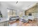 Spacious living room featuring hardwood floors, a stone fireplace, and sliding door access to the outdoor deck at 1205 Molokai Dr, Tega Cay, SC 29708