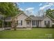 Charming single-story home featuring a well-maintained lawn, a covered carport, and a welcoming front entrance at 124 Woodside Ln, Lancaster, SC 29720