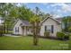 Inviting single-story home with a manicured lawn, classic siding, a carport, and a neatly landscaped front yard at 124 Woodside Ln, Lancaster, SC 29720