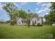 Attractive single-story home with a spacious front yard, traditional siding, dark shutters, and a welcoming entrance at 124 Woodside Ln, Lancaster, SC 29720