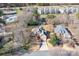 Stunning aerial view of a home with a long driveway, lush landscaping and community pool nearby at 126 Emerald Dr, Mooresville, NC 28117
