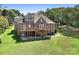 Spacious backyard featuring a wooden deck, walkout basement, and lush green lawn at 126 Emerald Dr, Mooresville, NC 28117