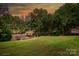 Beautiful backyard featuring a gazebo overlooking a large grassy lawn, and wooded area at 126 Emerald Dr, Mooresville, NC 28117