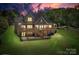 Backyard with patio, a wooden deck, and lush greenery perfect for outdoor entertaining at 126 Emerald Dr, Mooresville, NC 28117
