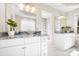 Bright bathroom features granite counters, dual sinks, white cabinets and a glass block window at 126 Emerald Dr, Mooresville, NC 28117