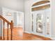 Inviting foyer with decorative glass door and sidelights, hardwood floors and chandelier at 126 Emerald Dr, Mooresville, NC 28117