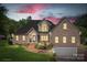Charming brick home with manicured lawn, beautiful landscaping, and attached two-car garage at 126 Emerald Dr, Mooresville, NC 28117